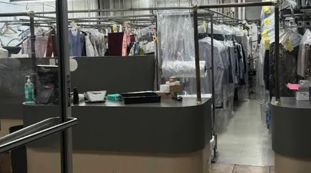 Inside Hillsdale Cleaners, the service counter and garment racks